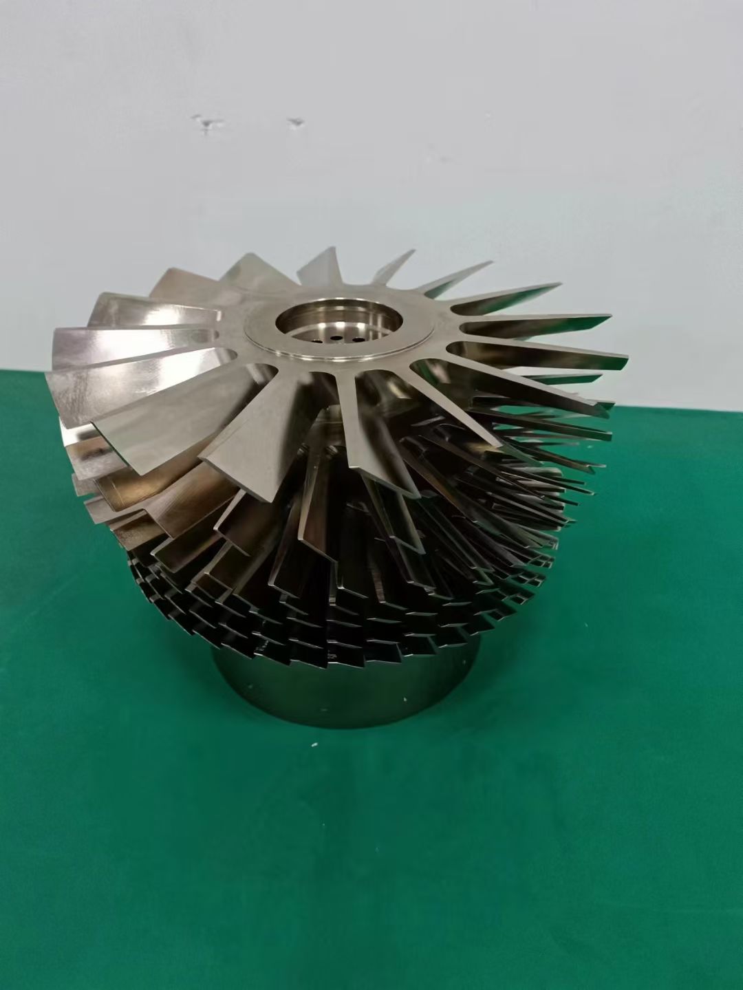Finished machined multi-blade impeller component photographed after processing